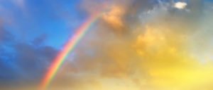 rainbow over mountain valley