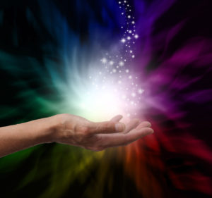 outstretched hand with multicolored ball of energy